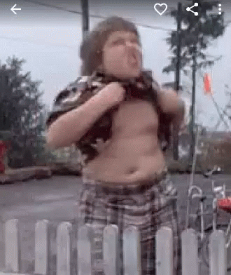 A Fat Boy Is Standing In Front Of A White Fence . GIF