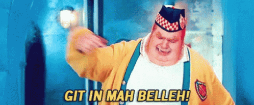 A Fat Man In A Yellow Jacket And Suspenders Is Saying Git In Mah Belleh GIF