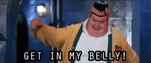 A Fat Man In A Yellow Sweater Is Saying Get In My Belly GIF