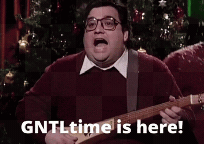 A Fat Man Is Playing A Guitar In Front Of A Christmas Tree And Saying `` Gntl Time Is Here '' . GIF