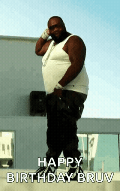 A Fat Man Is Standing In Front Of A Building With The Words Happy Birthday Bruv On The Bottom GIF