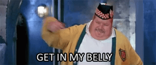 A Fat Man Wearing A Yellow Sweater And A Hat Is Dancing And Says `` Get In My Belly '' . GIF