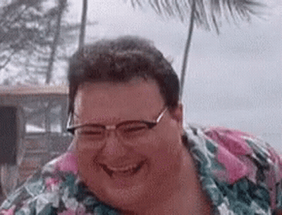 A Fat Man Wearing Glasses And A Floral Shirt Is Smiling . GIF