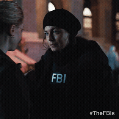 A Fbi Officer Is Talking To Another Woman GIF