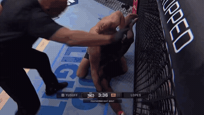 A Featherweight Bout Between Yusuff And Lopes Is Being Shown On A Screen GIF