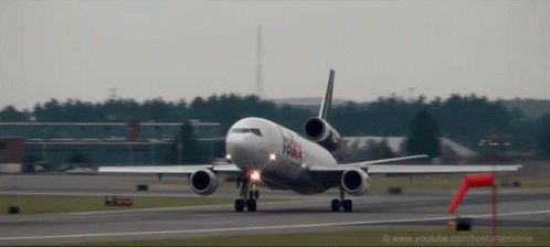 A Fedex Airplane Is Taking Off From An Airport GIF