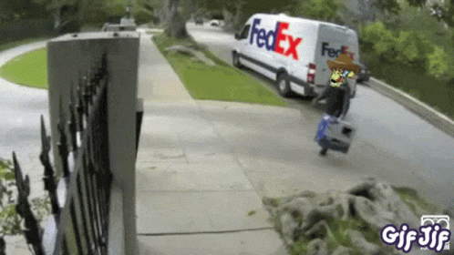A Fedex Van Is Driving Down The Street GIF