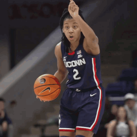 A Female Basketball Player For Uconn Is Standing On The Court GIF