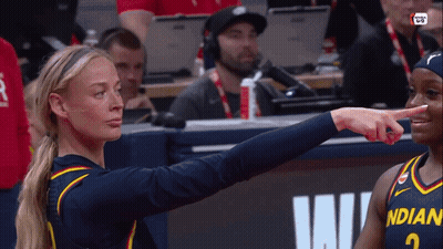 A Female Basketball Player Wearing A Jersey That Says Indian Pointing At Another Player GIF