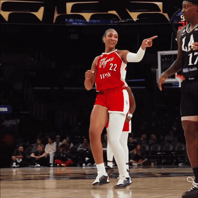 A Female Basketball Player Wearing A Red And White Uniform With The Number 22 On It GIF