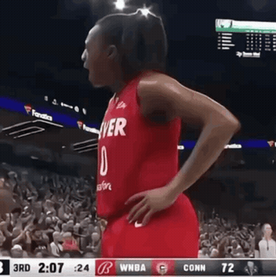 A Female Basketball Player Wearing A Red Jersey That Says Denver On It GIF
