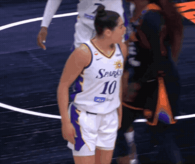 A Female Basketball Player With The Number 10 On Her Jersey Stands On The Court GIF