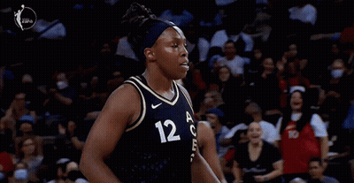 A Female Basketball Player With The Number 12 On Her Shirt GIF