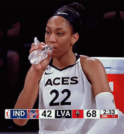 A Female Basketball Player With The Number 22 On Her Jersey Is Drinking Water GIF