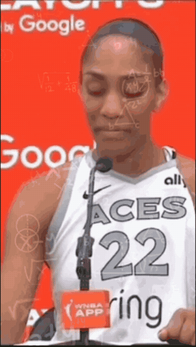 A Female Basketball Player With The Number 22 On Her Jersey Stands In Front Of A Microphone GIF