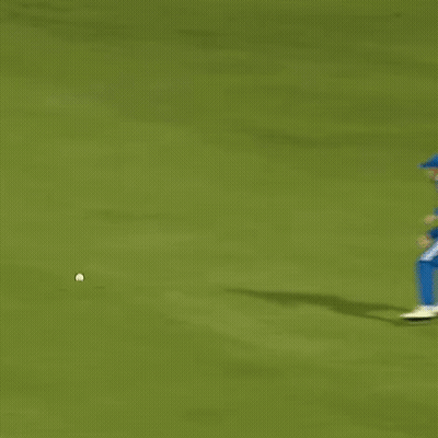 A Female Cricket Player In A Blue Uniform Is Running On The Field . GIF