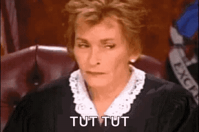 A Female Judge Is Sitting In A Courtroom And Saying Tut Tut . GIF