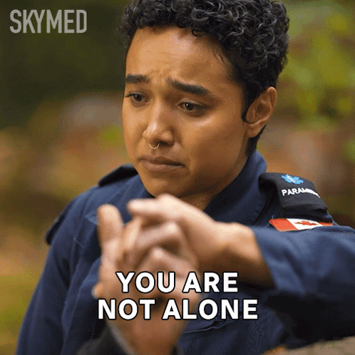 A Female Paramedic Says " You Are Not Alone " While Holding Another Person 'S Hand GIF