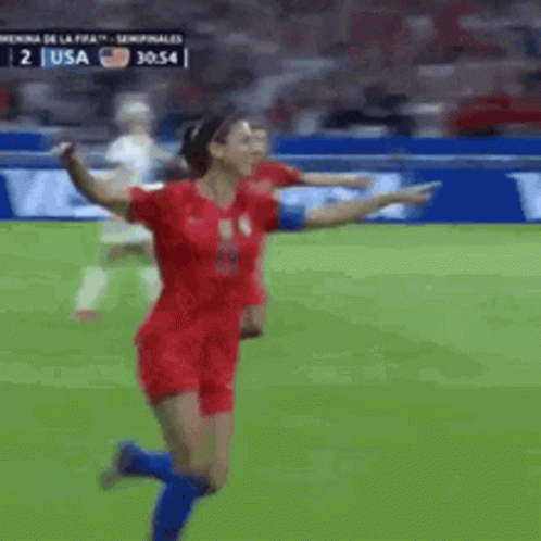 A Female Soccer Player In A Red Jersey Is Running On The Field GIF