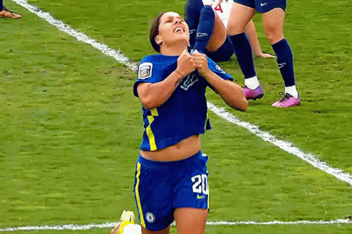 A Female Soccer Player Wearing Number 20 Is Kneeling On The Field GIF