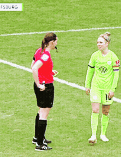 A Female Soccer Player With The Number 10 On Her Shorts Is Talking To A Referee GIF