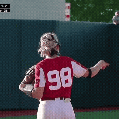 A Female Softball Player Wearing A Helmet And Glove With The Number 26 On Her Jersey GIF