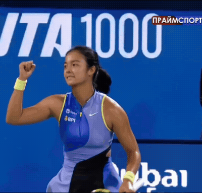 A Female Tennis Player Holds Her Fist In The Air In Front Of A Sign That Says " Ita 1000 " GIF
