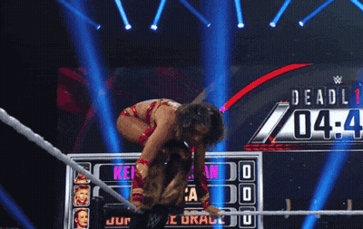 A Female Wrestler Is Kneeling Down In Front Of A Scoreboard That Says Deadli 04-4 GIF