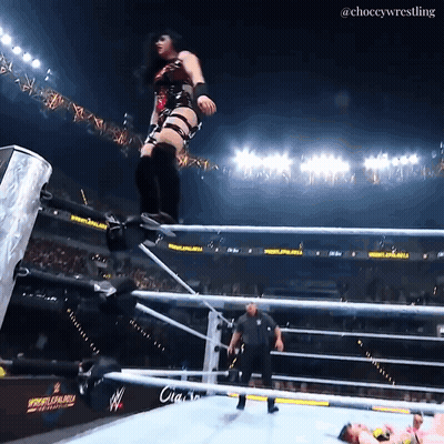 A Female Wrestler Jumps Over The Ropes At A Wrestlemania GIF