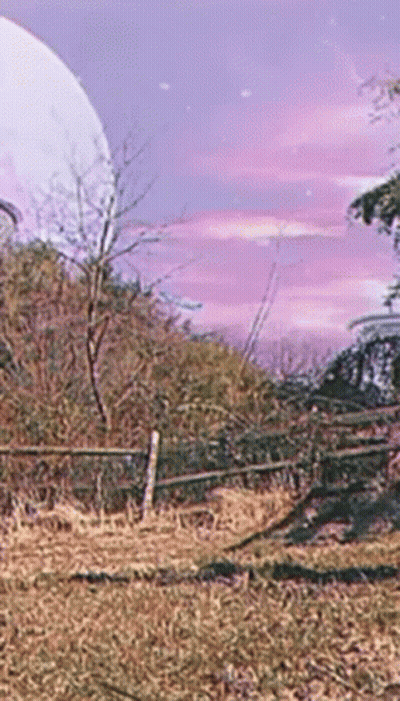 A Fence In A Field With A Full Moon In The Background GIF