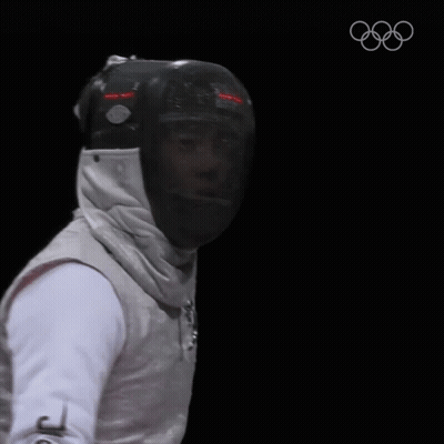 A Fencer Is Wearing A Helmet And Holding A Sword GIF