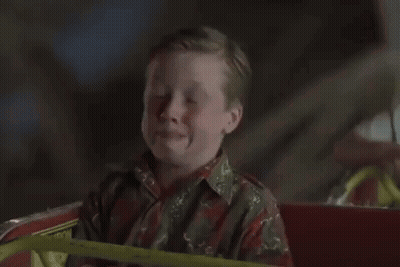 A Ferris Wheel Is Lit Up At Night GIF