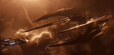A Few Spaceships Are Flying In A Cloudy Sky GIF