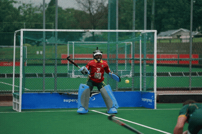 A Field Hockey Player Wearing A Red Jersey With The Number 21 On It GIF