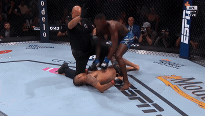 A Fighter Is Laying On The Ground In A Boxing Ring With The Espn Logo In The Background GIF