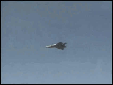 A Fighter Jet Is Flying In The Sky With A Cloud In The Background GIF