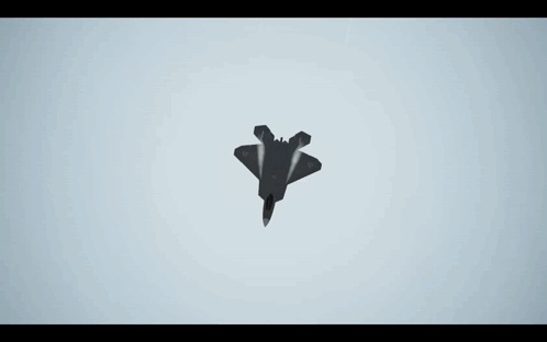 A Fighter Jet Is Flying Through A Cloudy Blue Sky GIF
