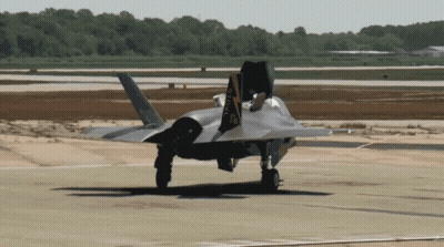 A Fighter Jet Is Taking Off From A Runway With The Letters Aa Visible On The Tail GIF