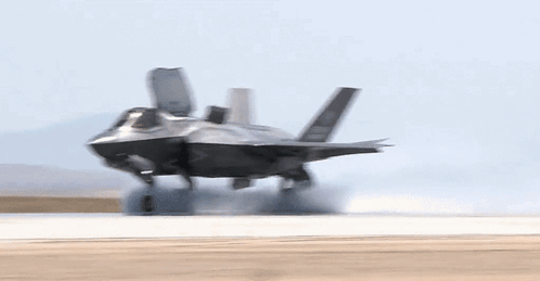 A Fighter Jet Is Taking Off From A Runway With The Letters Gp-34 On The Tail GIF