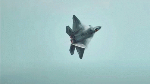 A Fighter Jet With The Letter F On The Tail Is Flying Through A Cloudy Blue Sky GIF