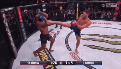 A Fighter Kicking Another Fighter In A Boxing Ring With The Score Of 3 To 5 GIF