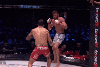 A Fighter With The Word Tebuli On His Shorts Is Fighting Another Man GIF