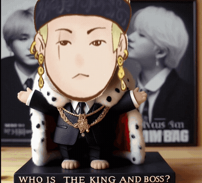 A Figurine Of A Man In A Suit And A Crown Is Sitting On A Book Titled Who Is The King And Boss GIF