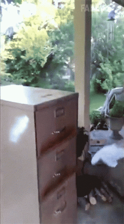 A Filing Cabinet Has The Number 3 On The Drawer GIF