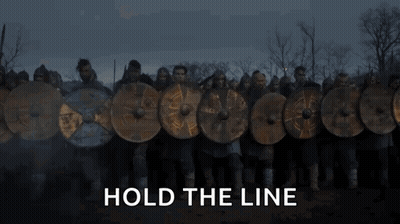 A Fire Is Burning In A Field With The Words `` Hold The Line '' Above It . GIF