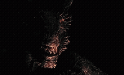 A Fireball Is Coming Out Of A Monster 'S Mouth In The Dark . GIF