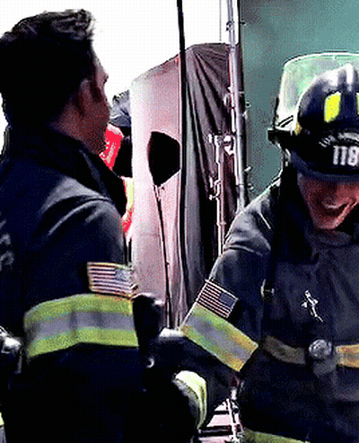 A Firefighter Wearing A Helmet That Says 118 On It GIF