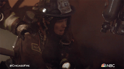 A Fireman With The Number 51 On His Helmet Holds A Flashlight GIF