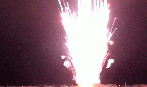A Fireworks Display Is Going Off In The Dark GIF
