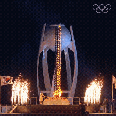 A Fireworks Display With The Olympic Rings On The Bottom Right GIF